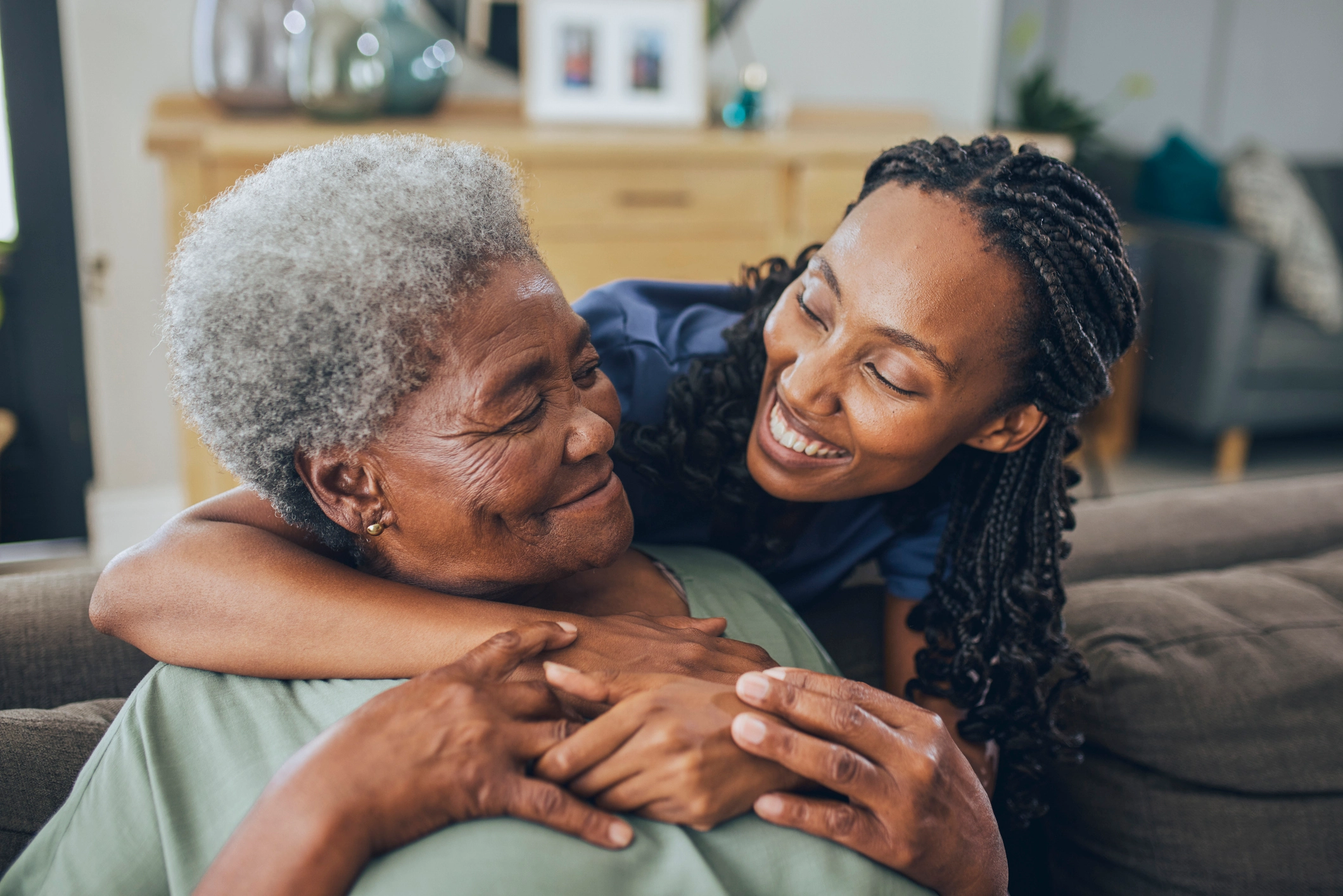 senior woman and her daughter hugging while talking about what is private home care in Charlton, MA.